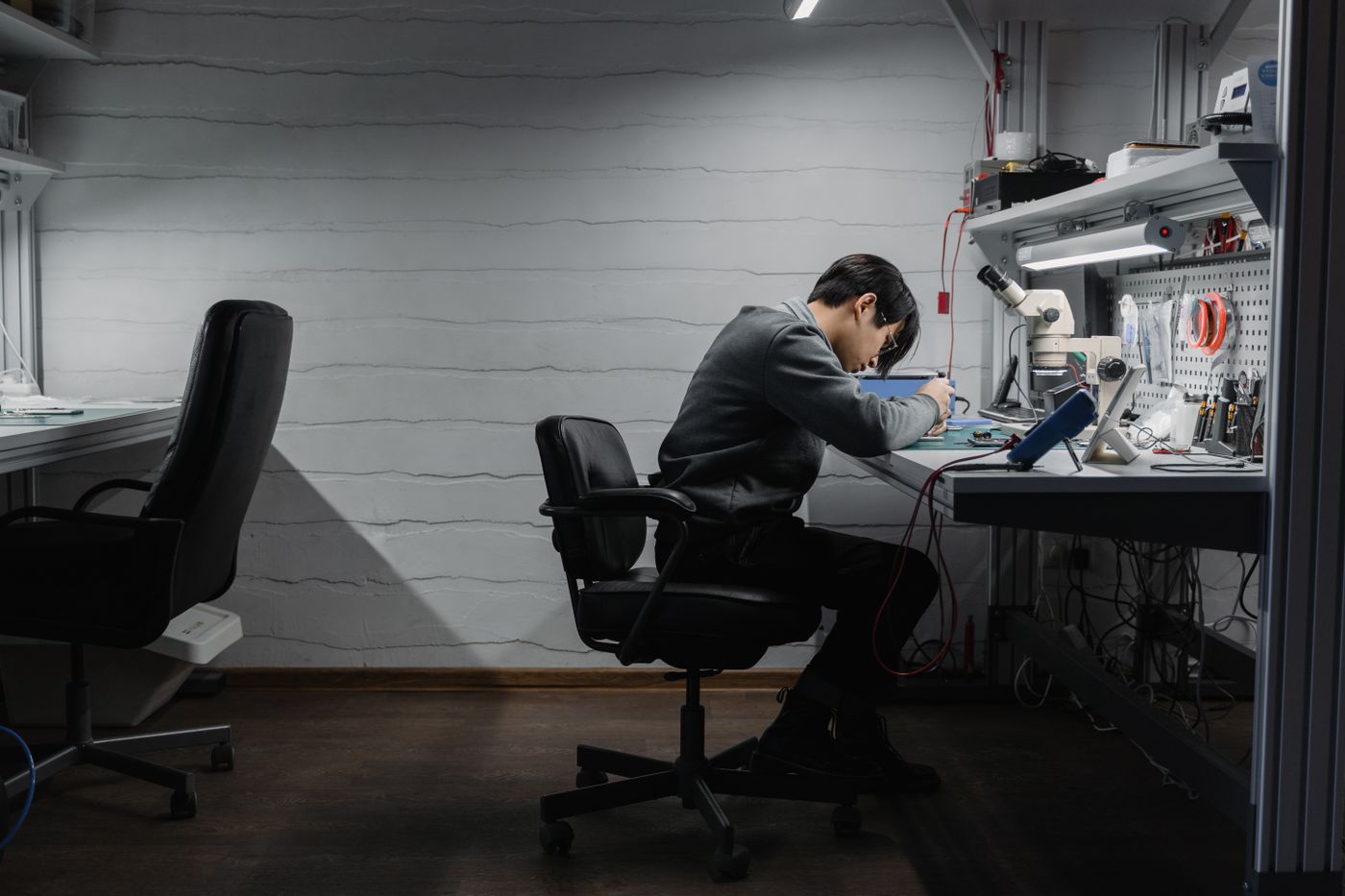 Engineer repairing electronics at a workbench