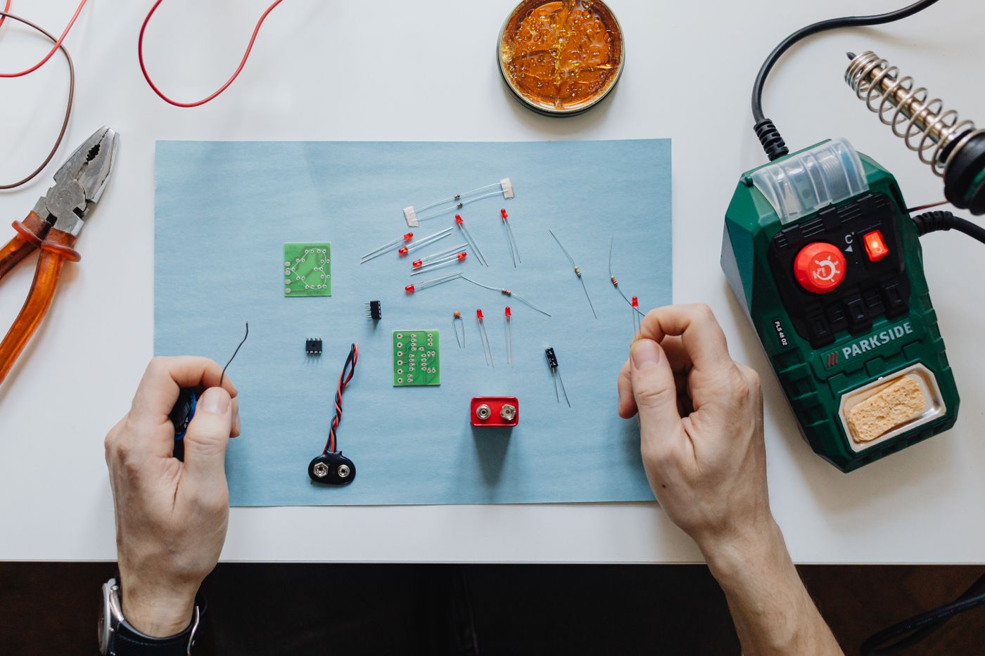 Electronics repair tools and circuit board on a workspace